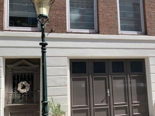 a building with two garage doors and a street light at Quietly located mansion near the centre of The Hague in The Hague