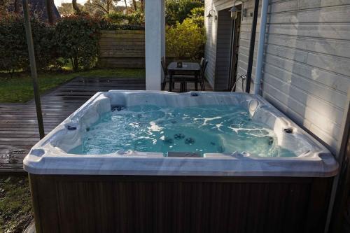 a hot tub on the side of a house at La Villa Bel Ange Hotel in Saint-Philibert