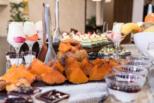 a table with a bunch of food and wine glasses at St George Ski & Holiday - Half Board & All Inclusive in Bansko