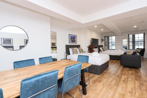a room with a bed and a table and chairs at Concert Square Apartments By Happy Days in Liverpool