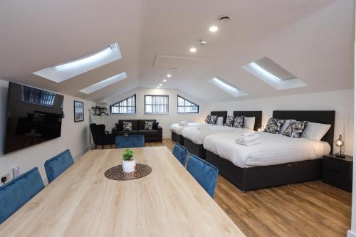 a bedroom with a large bed and a table and chairs at Concert Square Apartments By Happy Days in Liverpool