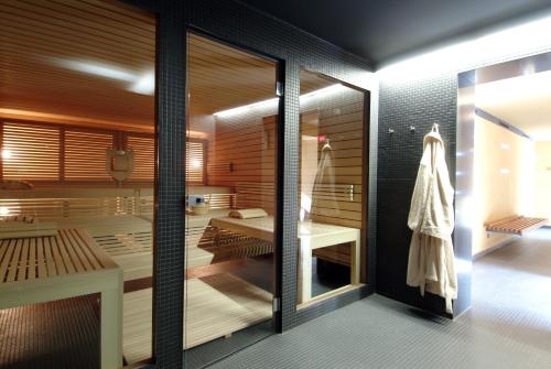 a bathroom with a shower and a sink and a mirror at Hotel Krone Sarnen in Sarnen