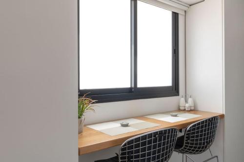 a table and two chairs in a room with a window at King George suites in Jerusalem