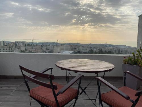 a table and chairs on a balcony with a view at King George suites in Jerusalem