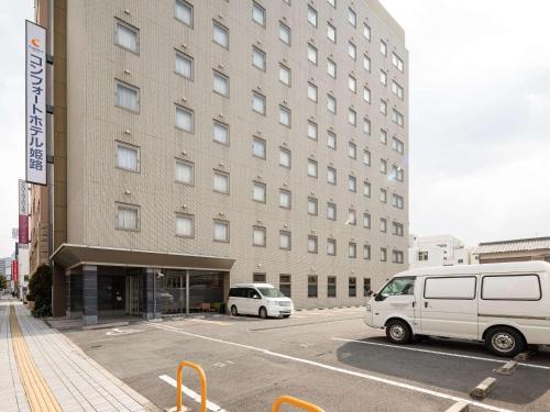 a white van parked in front of a building at Comfort Hotel Himeji in Himeji