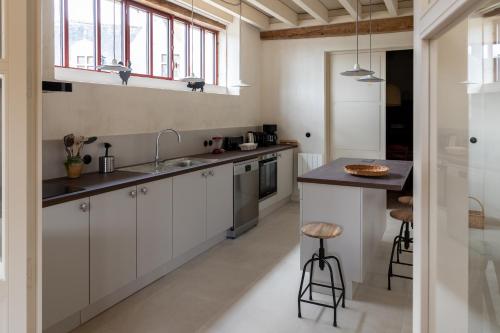 a kitchen with white cabinets and a sink and a counter at Gite de Vonnes in Pont-de-Ruan