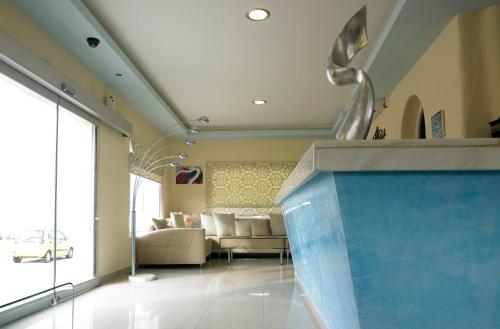 a living room with a large blue aquarium in the middle at Suites of the Gods Cave Spa Hotel in Megalochori