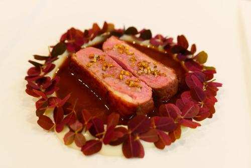 a plate of food with meat and sauce on it at Seehotel Hartung & Ferienappartements in Füssen