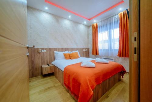 a bedroom with a bed with two towels on it at Balkan Hill Zlatibor in Zlatibor