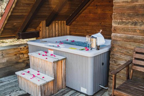 a hot tub in the middle of a wooden building at Wooden Cabin Zurej with Hot Tub in Bukovje v Babni Gori