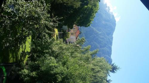 a building on the side of a hill with trees at Ferienwohnung Holiday Lienz in Lienz
