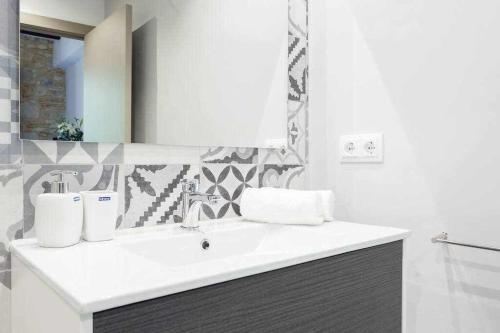 a bathroom with a white sink and a mirror at Sleep y Stay Home with balcony Bonaventura 3 in Girona