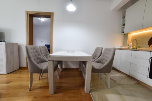 a kitchen with a table and chairs in a room at Balkan Hill Zlatibor in Zlatibor