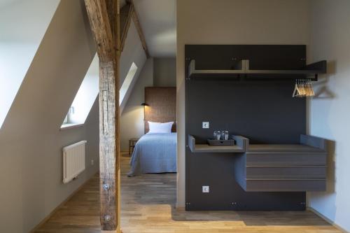 a room with a loft bed and a bedroom at Hotel Sonne in Zittau