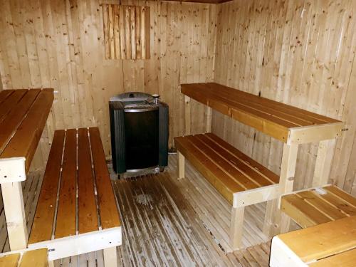 a wooden room with benches and a small television in it at Toscana Wellness Resort in Arcidosso