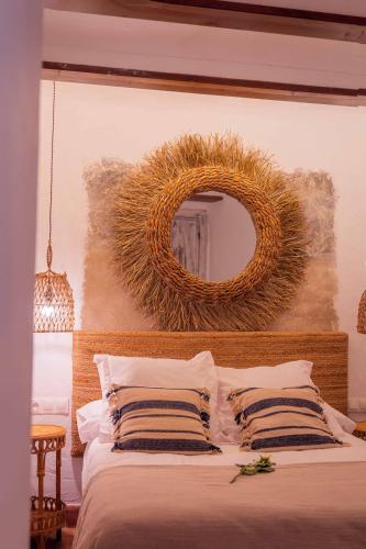 a bedroom with a bed with a mirror on the wall at CANDIL SUITE Realejo in Granada