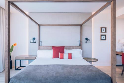 a bedroom with a large bed with red pillows at Iberostar Selection Llaut Palma- Adults Only in Playa de Palma