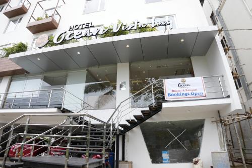 a building with a staircase in front of a store at HOTEL OCEAN VISTA BAY in Visakhapatnam