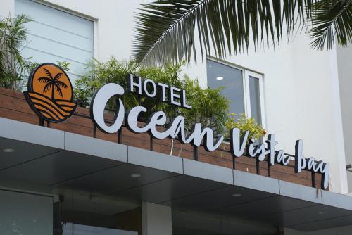 a hotel oceanview sign on top of a building at HOTEL OCEAN VISTA BAY in Visakhapatnam