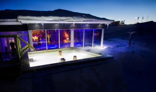 a bath tub with two people in it at night at Camp Ripan in Kiruna