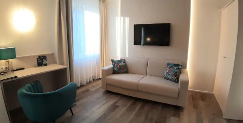 a living room with a couch and a tv at Hotel-Restaurant Gollner in Lebring