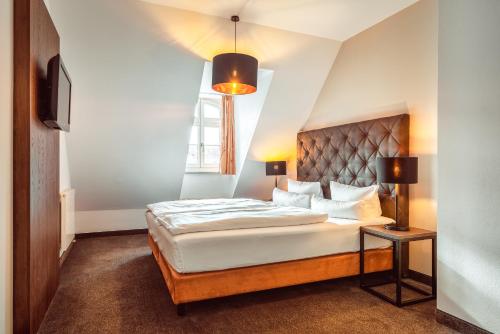 a bedroom with a large bed and a window at Familienapartment Am Neumarkt l in Dresden