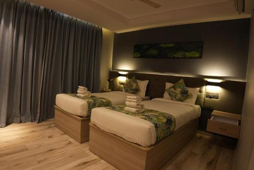 a hotel room with two beds and a window at HOTEL OCEAN VISTA BAY in Visakhapatnam
