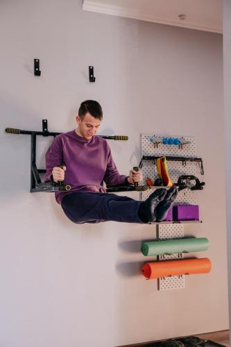 a man sitting on a shelf in a wall at People Hostel in Bishkek