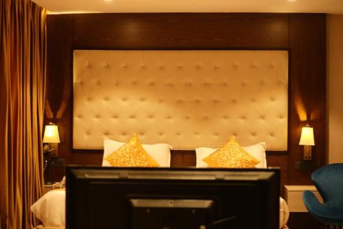 a hotel room with a bed and a television at HOTEL OCEAN VISTA BAY in Visakhapatnam