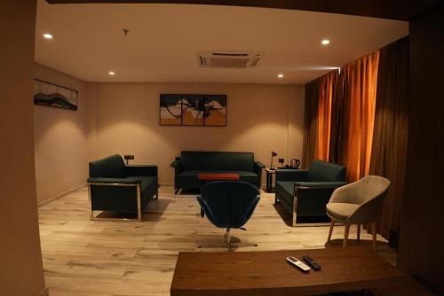 a waiting room with couches and chairs and a table at HOTEL OCEAN VISTA BAY in Visakhapatnam