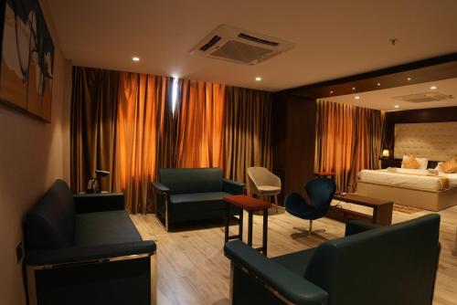a hotel room with a bed and a living room at HOTEL OCEAN VISTA BAY in Visakhapatnam