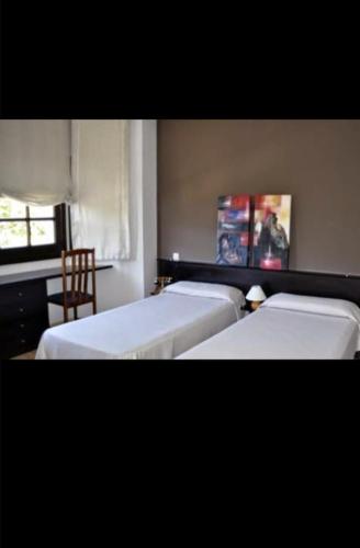 Ένα ή περισσότερα κρεβάτια σε δωμάτιο στο Hostal Asador Julian