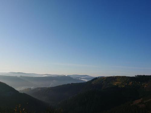 a view from the top of a mountain with a foggy valley at Ferienwohnung Sunnenviul in Lennestadt