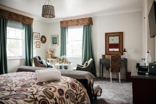 a bedroom with a bed and a desk and a mirror at The Naight House in Gloucester