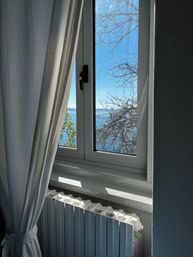 a window with a view of the ocean at Villa Tergeste in Trieste