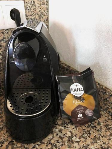 a black toaster on a counter with a bag of food at Casa Rautau in Soajo