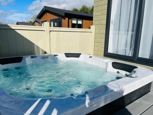 a hot tub sitting on top of a balcony at Bridgewater Lodge with Hot Tub in York