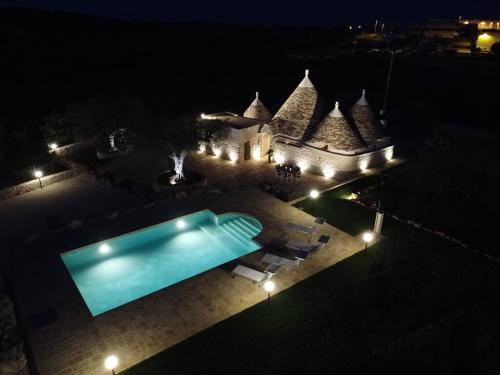 an overhead view of a swimming pool at night at Quattroperle Trulli - Relax - Puglia in Castellana Grotte