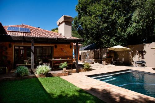 a backyard with a swimming pool and a house at 37 on Charles in Pretoria