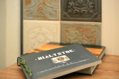 a book sitting on top of a wooden table at Kamienica Boutique ApartHotel in Białystok