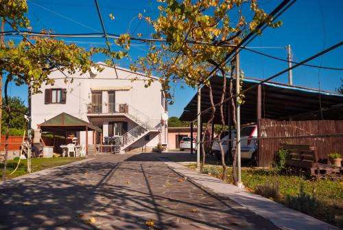 a house on a street with a building at Appartamenti L'Arcipelago in Marina di Campo