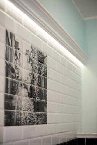 a wall with black and white pictures on it at Kamienica Boutique ApartHotel in Białystok