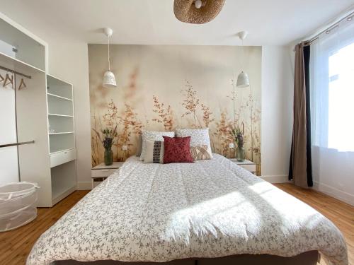 a bedroom with a large bed with a white bedspread at Résidence Adam à part in Valenciennes