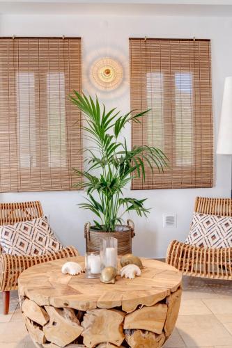 a living room with a wooden table and chairs at Hotel Benois in Galissas