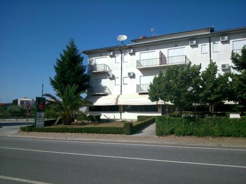 a white building with balconies on the side of a street at A Muralha in Almeida