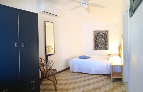 a bedroom with a bed and a ceiling fan at La Terrazza sul Mare di Teodora in Pantelleria