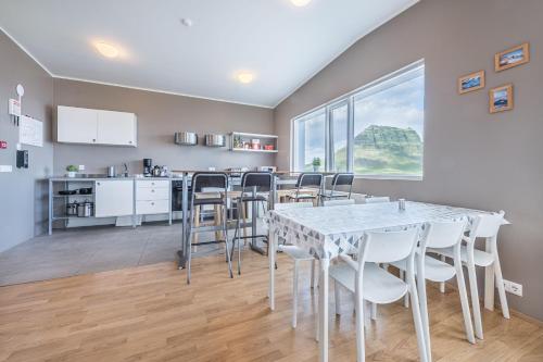 a kitchen and dining room with a table and chairs at Stöð Guesthouse and apartments in Grundarfjordur