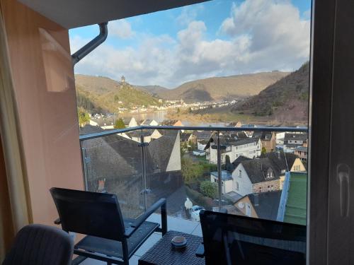 a balcony with a view of a city and mountains at Anitas Ferienhaus in Cochem