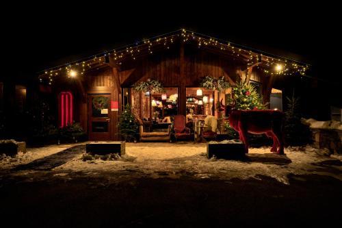 a house decorated with christmas lights and a horse outside at Mamie Megève in Megève
