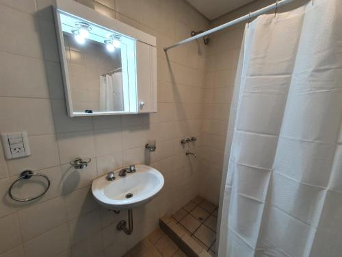 a bathroom with a sink and a shower with a mirror at Casa Las Lengas in Ushuaia